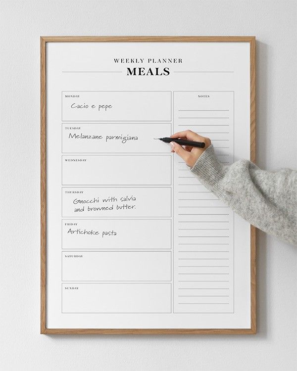 Kitchen table with weekly activity planner and colored markers for household scheduling